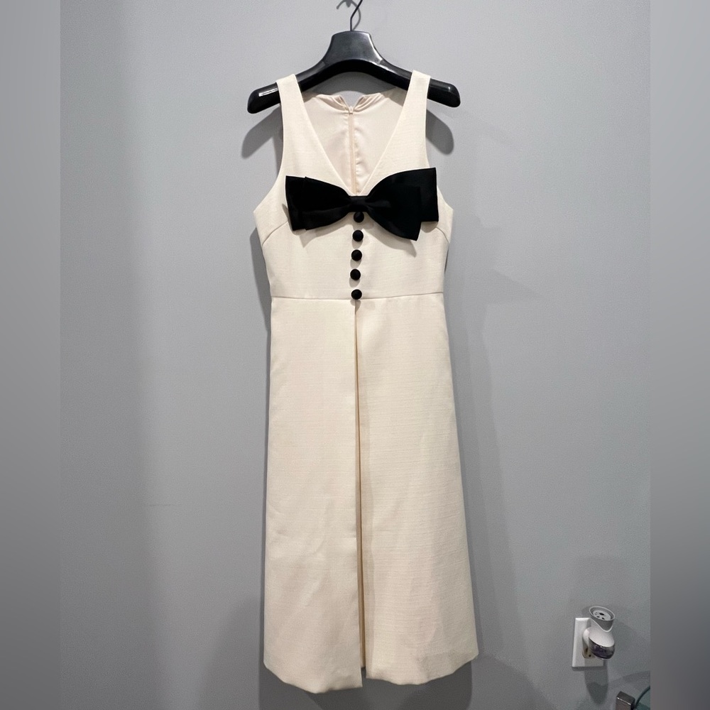 A white dress with black bow tie